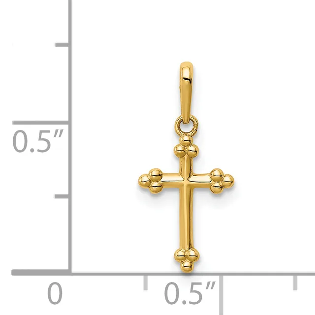 A gold cross pendant with decorative beaded ball details at the ends and intersections, shown next to a measurement scale indicating its size is approximately half an inch wide.