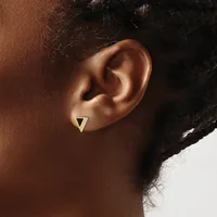 A small gold triangular stud earring worn in a pierced earlobe, shown in profile against a neutral background.