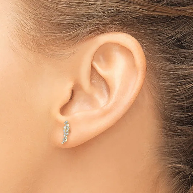 A person wearing a vertical diamond hoop earring in their pierced earlobe, shown in profile against their shoulder-length brown hair.