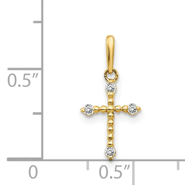 Gold cross pendant with diamond accents at each end and top, shown next to a ruler indicating approximately half inch width.
