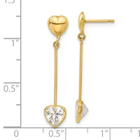 A pair of gold drop earrings with polished heart studs at the top and faceted cubic zirconia hearts suspended below, shown against a measurement scale.