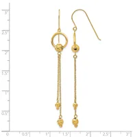 Pair of gold dangle earrings with textured chains, small beads, and circular loop details at the top, displayed against a measurement scale.
