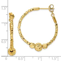Gold-toned hoop earrings with textured barrel-shaped beads and three larger decorative spheres at the bottom, shown against a measurement scale.