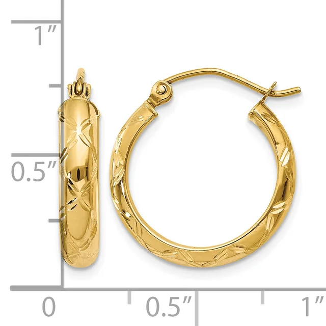 A pair of gold hoop earrings with a textured diamond-cut surface, displayed next to a ruler showing approximately one inch in length.