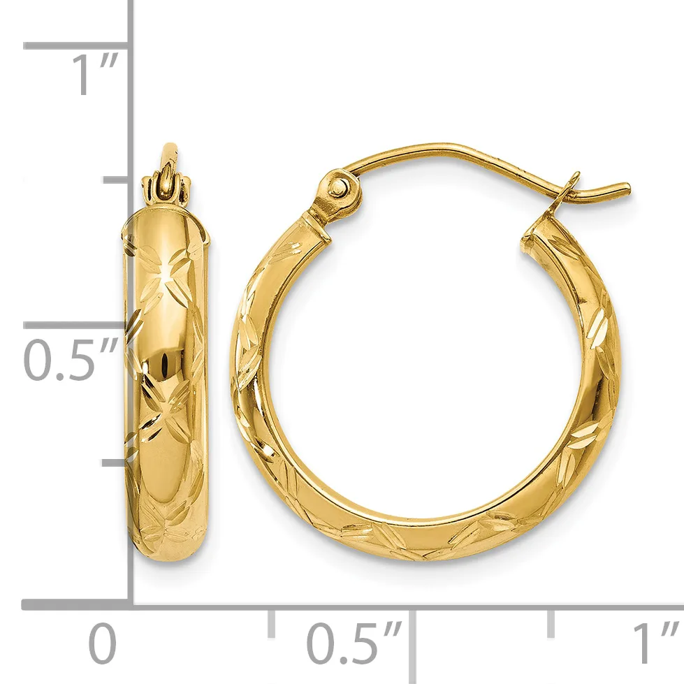 A pair of gold hoop earrings with a textured diamond-cut surface, displayed next to a ruler showing approximately one inch in length.