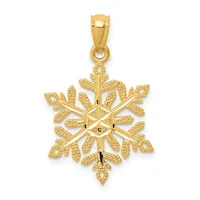 A gold snowflake pendant with textured petals and a polished center, suspended from a bail loop.