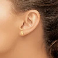 A person wearing a small gold textured hoop earring in their earlobe, shown in profile from the side of their face and ear.
