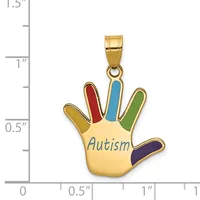 Gold-toned hand-shaped pendant with colored enamel fingers in red, blue, green, yellow, and dark blue, the palm inscribed with "Autism" in blue lettering, shown next to a ruler for scale.