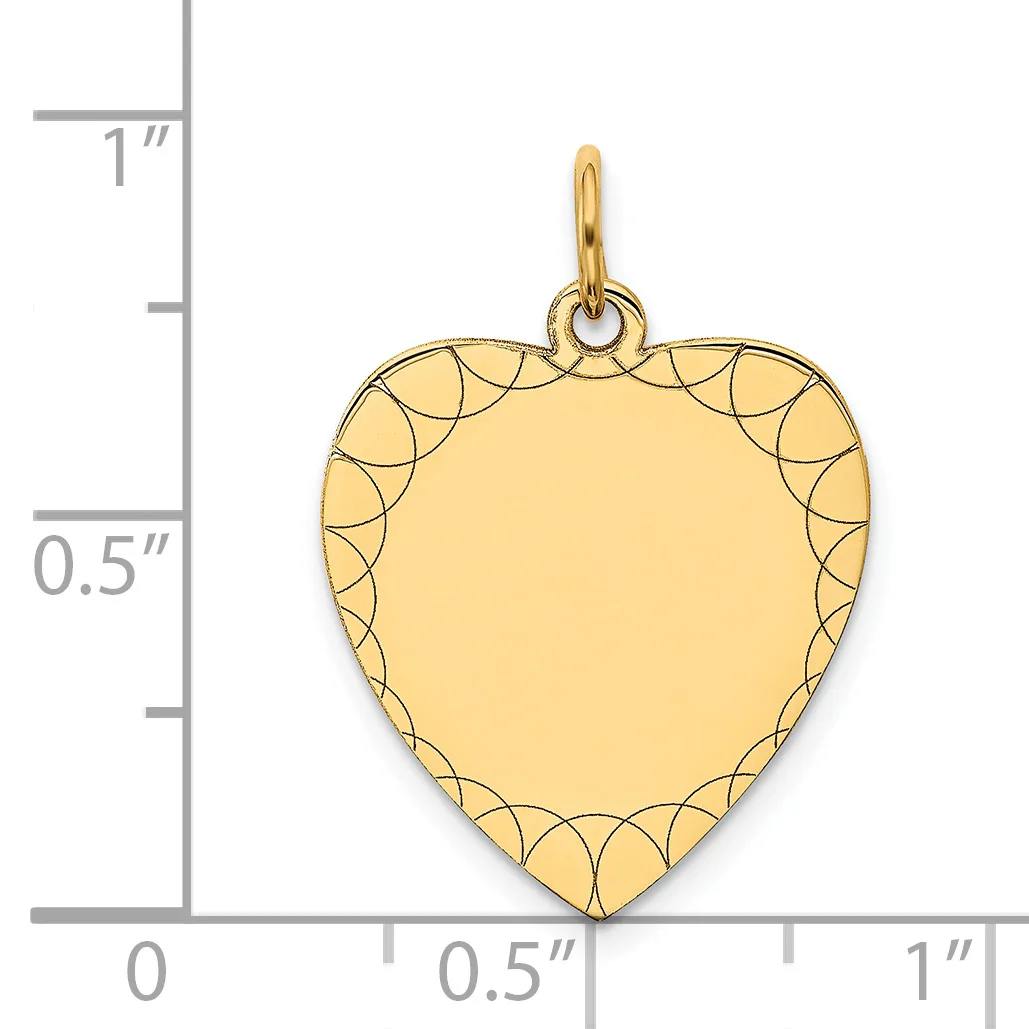 Gold-colored heart-shaped pendant with decorative scalloped border design, shown next to a ruler for scale.