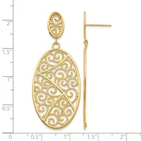 Pair of gold filigree dangle earrings with oval ornamental designs, displayed against a measurement scale.