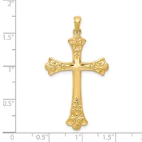 Gold ornate cross pendant with floral filigree details on the arms and shaft, displayed against a ruler showing approximately two inches in height.