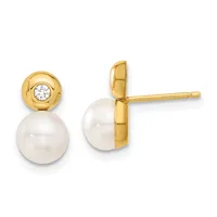 Pair of gold stud earrings featuring white pearl drops suspended below gold caps set with small round diamonds.
