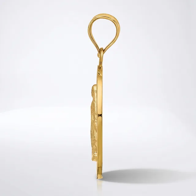 A gold pendant with an oval loop at the top and a decorative leaf or feather-shaped charm hanging below, shown from the side against a white background.