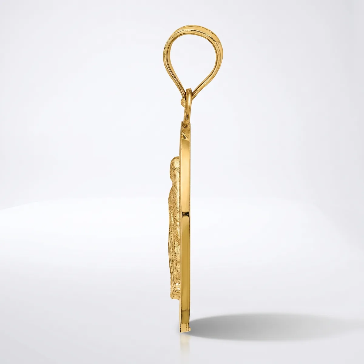 A gold pendant with an oval loop at the top and a decorative leaf or feather-shaped charm hanging below, shown from the side against a white background.