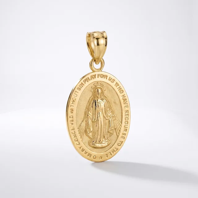 Gold oval religious medal pendant with relief image of a robed figure and text around the border, suspended from a gold bail on white background.