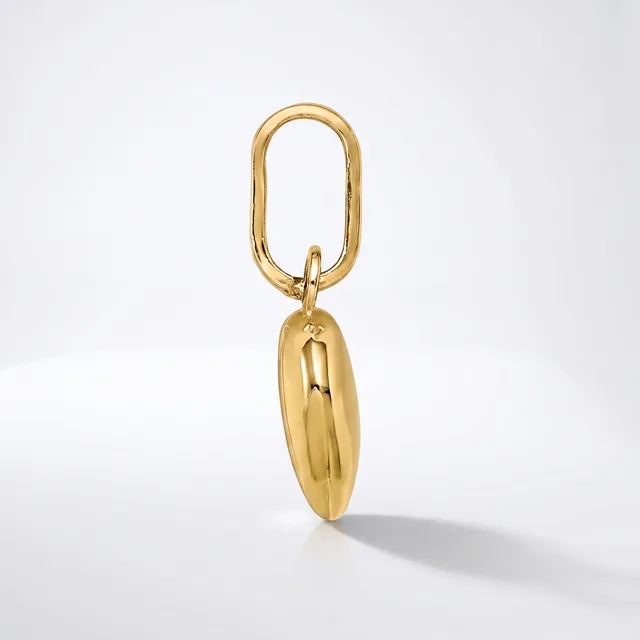 A polished gold-toned oval keychain with an elongated oval pendant hanging from it against a white background.