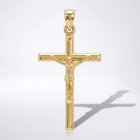 A gold crucifix pendant with a polished finish and detailed corpus figure, shown against a white background with its shadow visible.