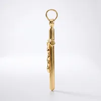 A gold-colored metal keychain pendant with a cylindrical body and decorative charm details attached to a ring loop at the top.