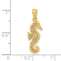 Gold seahorse pendant with filigree detailing shown next to a measurement scale indicating approximately one inch in length.