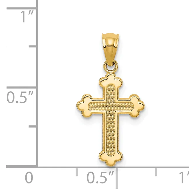 Gold cross pendant with textured center and rounded lobed ends, shown next to a ruler indicating approximately one inch in height.