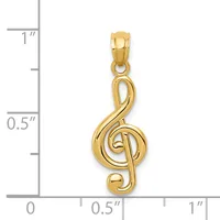 Gold treble clef pendant shown against a ruler measuring approximately one inch in height.