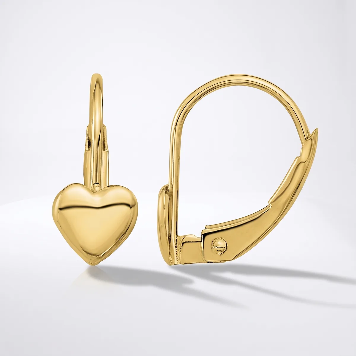 A pair of polished gold leverback earrings, each with a small puffed heart charm hanging from a hinged hoop, shown against a light gray background.