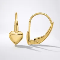 A pair of polished gold leverback earrings, each with a small puffed heart charm hanging from a hinged hoop, shown against a light gray background.