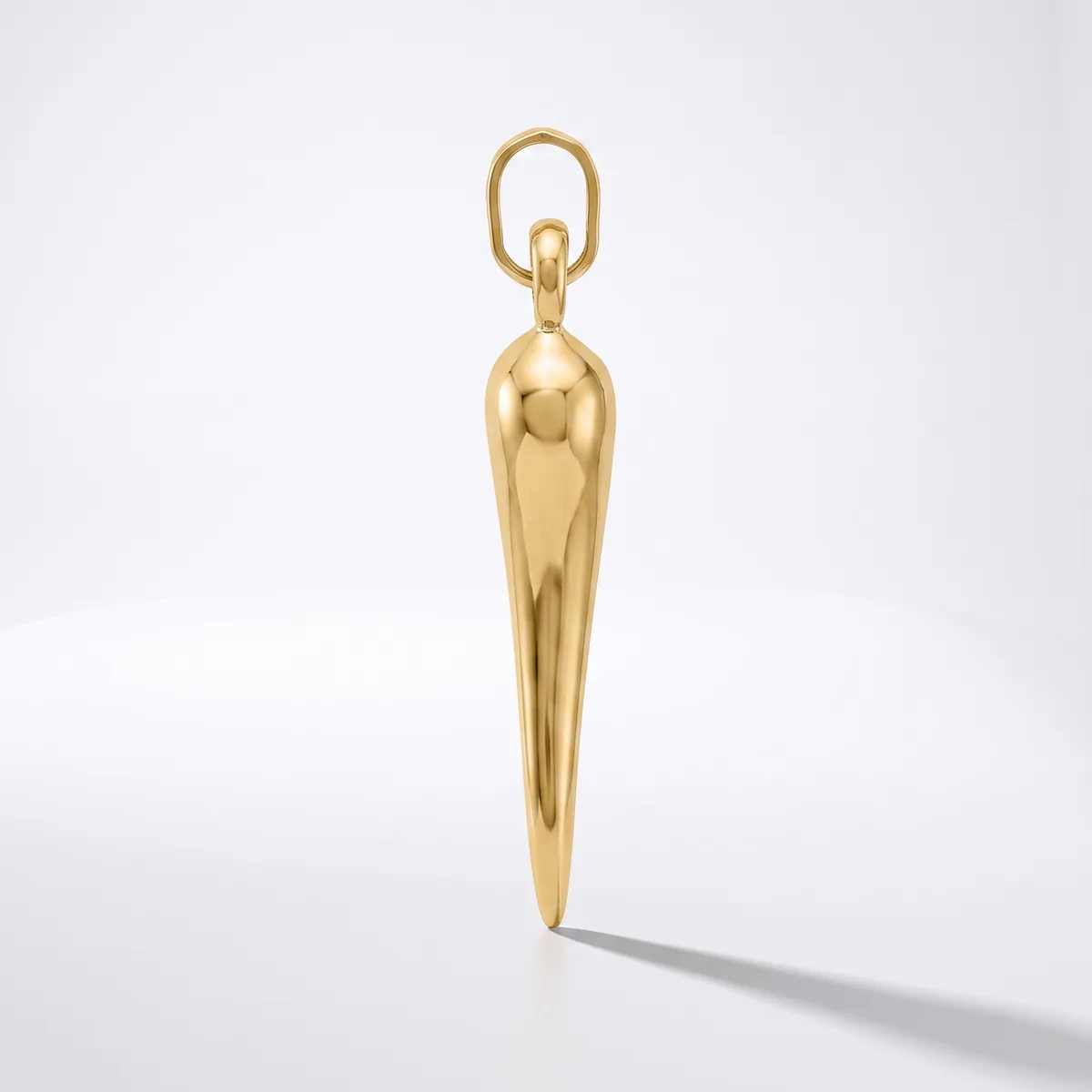 A polished gold-colored elongated teardrop pendant with a looped bail attachment, displayed vertically against a white background.