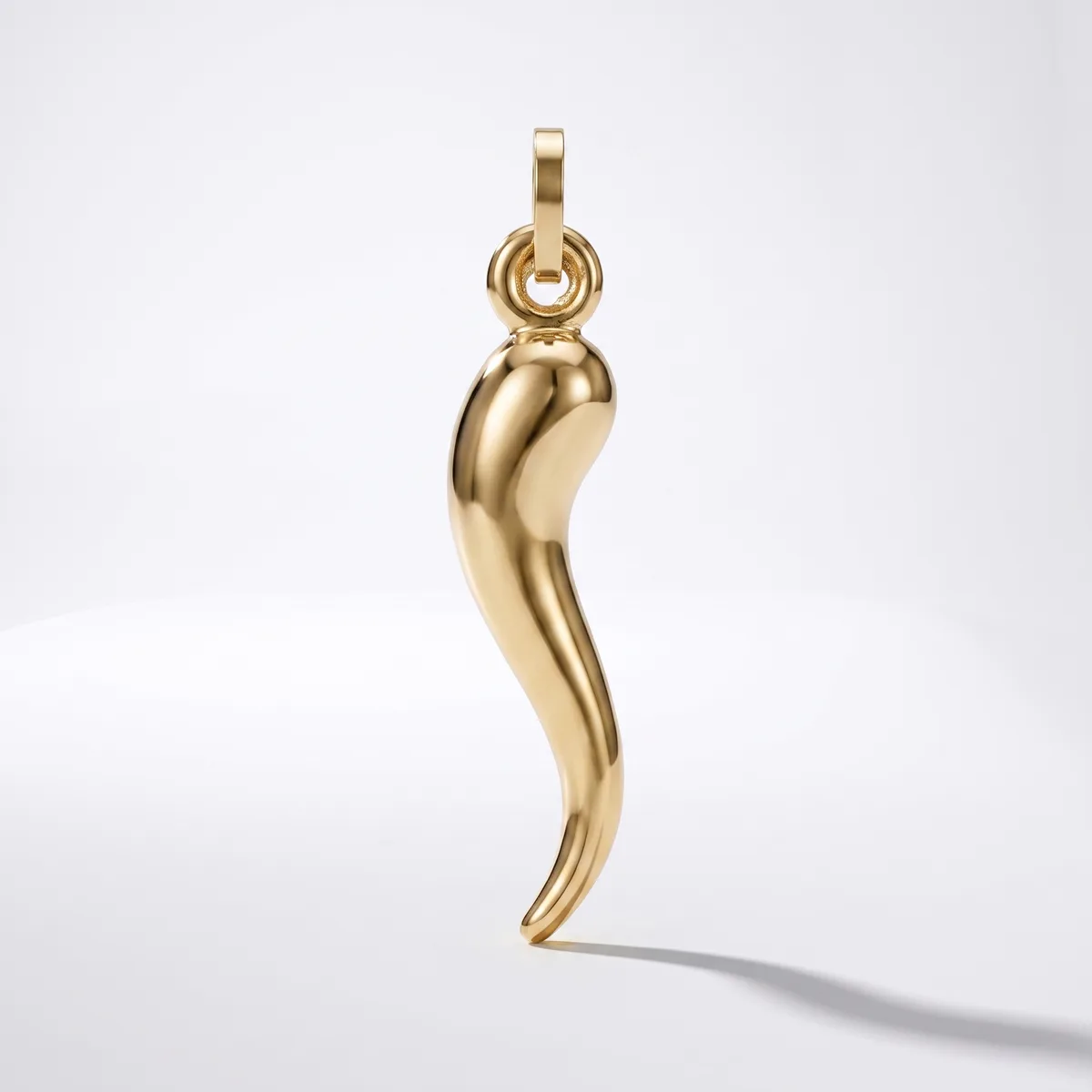 A polished gold curved horn-shaped pendant with a loop attachment at the top, displayed against a white background.