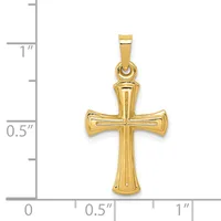 Gold cross pendant with hollow tapered arms and vertical ridged details, shown next to a ruler for scale indicating approximately one inch in height.