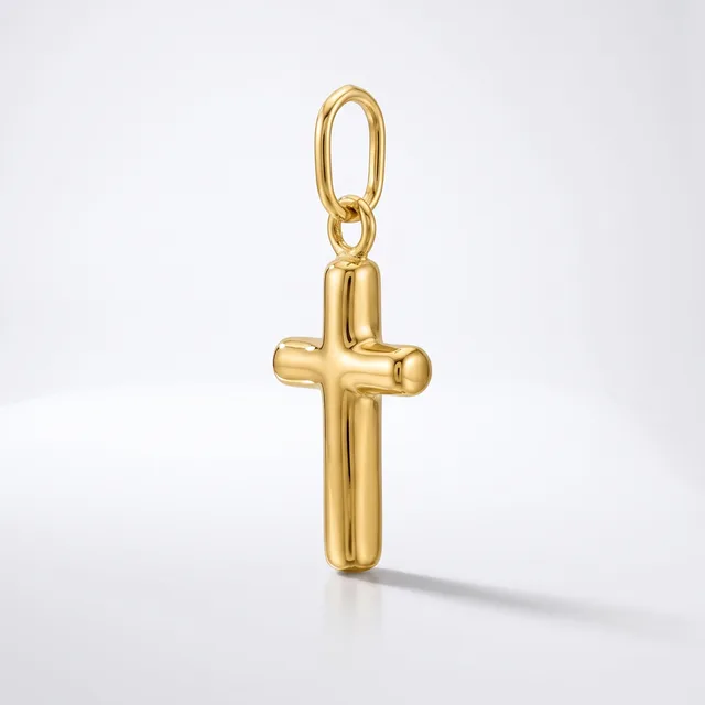A polished gold cross pendant with rounded edges hangs from a small oval bail loop against a white background.