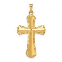 A gold cross pendant with beaded edges and a polished center, suspended from a bail, displayed against a white background.