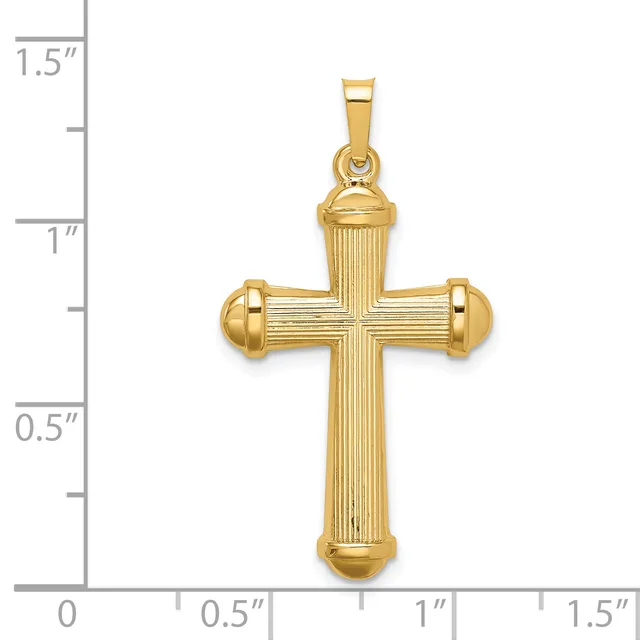 A gold cross pendant with vertical ribbed texture and rounded bulbous ends, shown next to a ruler measuring approximately one inch wide and one and a quarter inches tall.