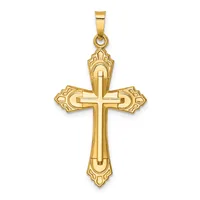 A gold cross pendant with ornate flared ends and a raised center cross, suspended from a small bail loop.