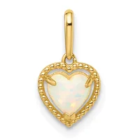 Gold heart-shaped pendant with white opal center stone, beaded gold border, and hanging bail, shown against white background.
