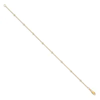A delicate gold-toned chain bracelet with small beaded details evenly spaced throughout, featuring a clasp at one end and a teardrop charm at the other.