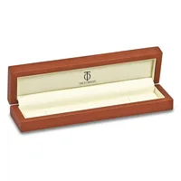 An open wooden jewelry box with a reddish-brown finish and cream-colored interior lining, displayed at an angle against a white background.