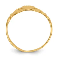 A yellow gold signet ring with an oval engraving plate, decorative rope border, textured scroll detailing on the shoulders, and a slim polished band, photographed from the side.