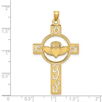 Gold-toned Claddagh cross pendant with a heart, crown, and wings in a circle at the center, decorative scrollwork on the cross arms, shown against a measurement scale.