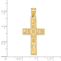 Gold cross pendant with "JESUS" inscribed vertically and a small cross at the bottom, shown against a ruler measuring approximately 1.25 inches tall.