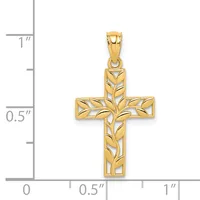 A gold cross pendant with a leaf pattern cutout design, shown next to a measurement scale indicating its size is approximately one inch tall and half an inch wide.