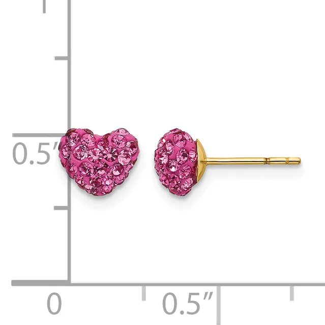 A pair of pink crystal heart-shaped stud earrings with gold posts displayed on a measurement scale.