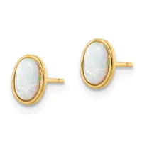 A pair of oval opal stud earrings set in yellow gold with beaded bezels and matching posts against a white background.