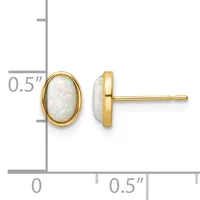 Pair of oval opal stud earrings with gold bezels and posts, shown front and side view against a measurement scale.
