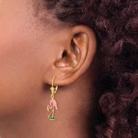 A person wearing a gold-toned lever-back earring with a pink enamel flamingo charm pendant dangling below.