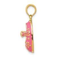 Gold-toned metal charm pendant with pink enamel coating, decorated with a bow motif and dotted pattern, attached to a gold loop bail.