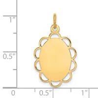 Gold oval pendant with scalloped border detail, shown next to a ruler measuring approximately one inch in length.