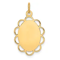 A gold pendant with an oval polished center surrounded by a scalloped edge with cutout loops, suspended from a small bail loop.