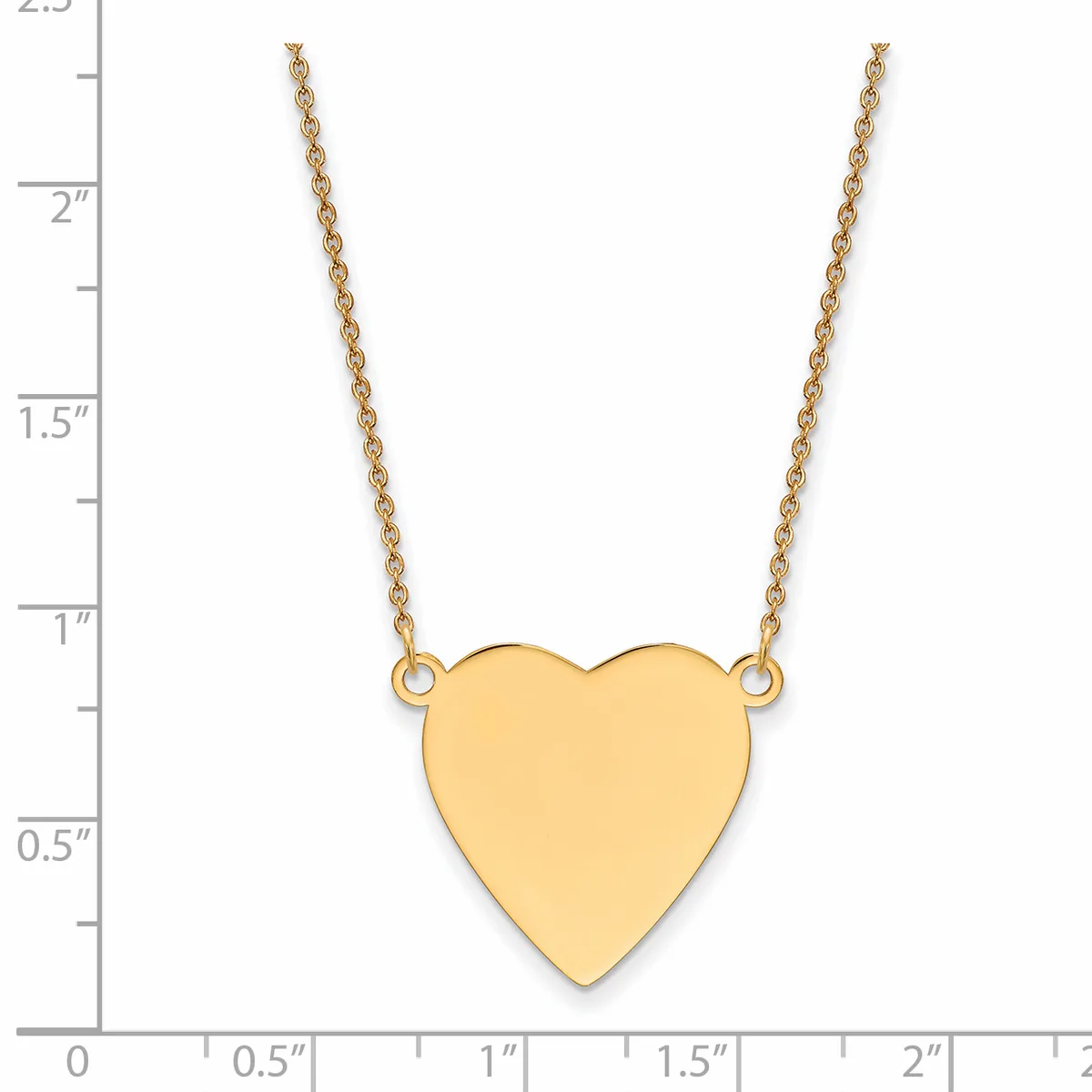 A gold heart pendant hangs from a delicate gold chain, shown against a ruler measuring approximately 2.25 inches in height.