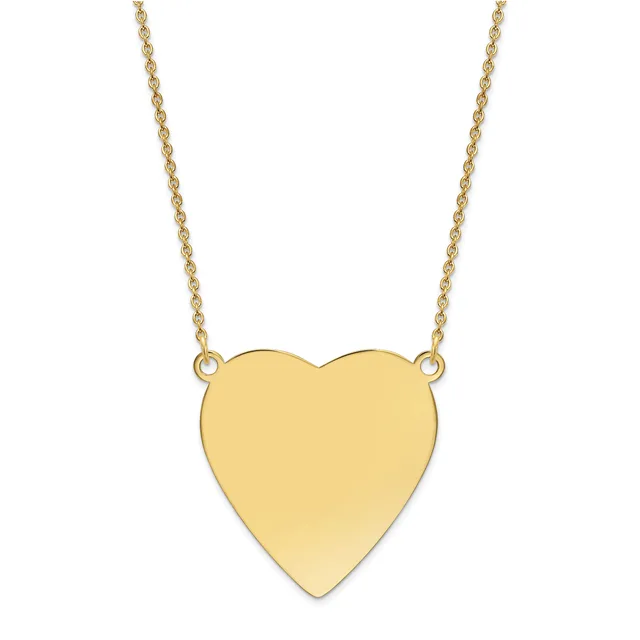 Gold heart pendant suspended from a delicate gold chain necklace.